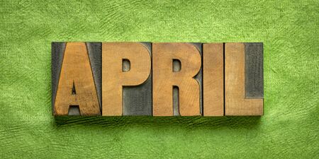 April month banner - word in vintage letterpress wood type against green handmade textured paper - calendar conceptの写真素材