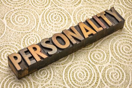 personality word in vintage letterpress wood type against lace paper with spiral patter, character, temperament and charisma conceptの写真素材