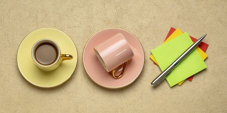 cups of coffee and reminder notes flat lay, workspace, office or business conceptの写真素材