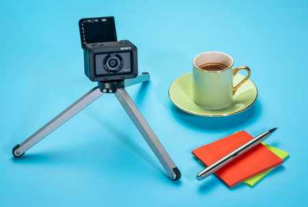 Fort Collins, CO, USA - December 8, 2019: Sony RX0 2 ultra compact robust camera on a mini table tripod with flipped LCD screen and a cup of coffee, vlogging concept.のeditorial素材