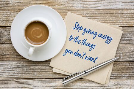 Stop giving energy to the things you do not want - inspirational handwriting on a napkin with...