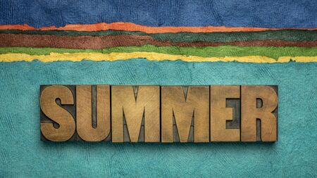 summer word in vintage letterpress wood type against abstract sea and beach landscape created with handmade textured paper - travel, vacation and recreation conceptの写真素材