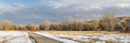 winter scenery on a bike trail - panorama of Poudre River Trail in northern Colorado, biking, recreation and commuting conceptの写真素材