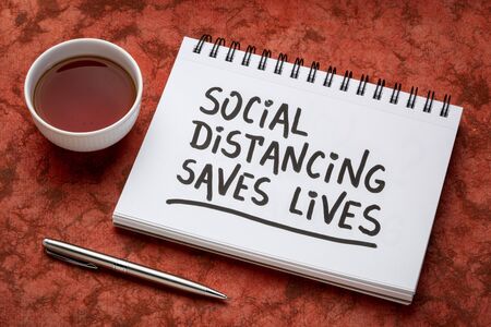 social distancing saves lives reminder - handwriting on a  sketchbook, covid-19 coronavirus pandemic recommedationの写真素材