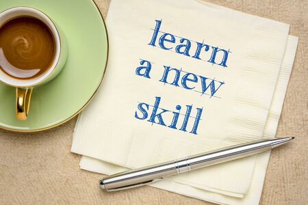 learn a new skill motivational note - handwriting on a napkin with a cup of coffee, personal...
