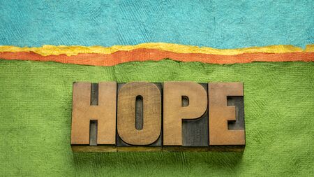 hope word - word abstract in vintage letterpress wood type against abstract paper landscape, positivity, faith and  optimism conceptの写真素材