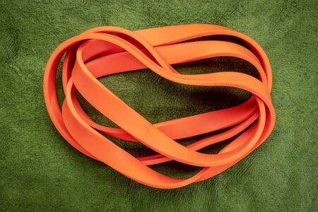 resistance exercise band for fitness and rehabilitation against green background