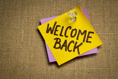 welcome back - handwriting on a sticky note, business reopening conceptの写真素材