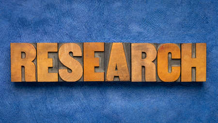 research word abstract in vintage letterpress wood type, investigation, study, business and science conceptの写真素材