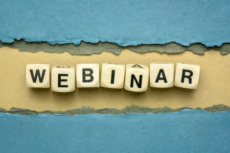 webinar word abstract inwooden cubes against handmade textured paper, web banner, internet presentation and communication conceptの写真素材