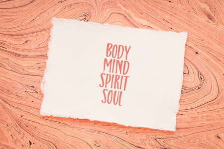 body, mind, soul, spirit - personal growth or development concept - handwriting on a handmade paperの写真素材