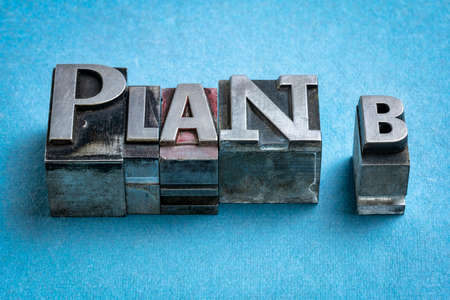 plan b - word abstract in vintage letterpress metal type against blue textured paper, revision and...