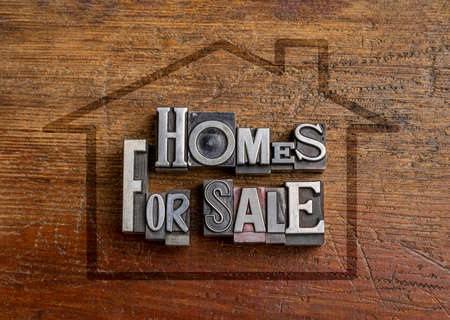 homes for sale word abstract in gritty vintage letterpress metal type, mixed fonts, against rustic...
