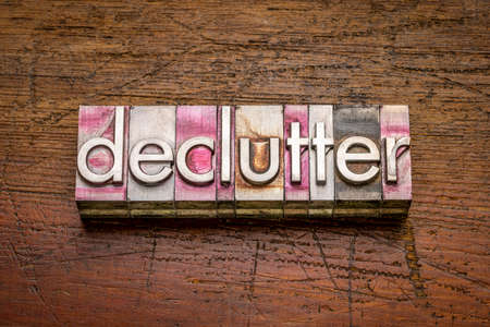 declutter word abstract in gritty vintage letterpress metal types against rustic weathered wood, business, lifestyle and personal development conceptの写真素材