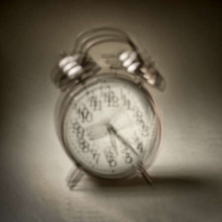 wake up, alarm clock ringing - blurred soft focus black and white image shot with a lensless pinhole...
