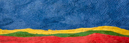 blue sky over hills panorama  - colorful landscape abstract created with sheets of handmade textured bark paper, web bannerの写真素材