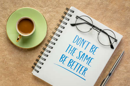 Do not be the same, be better. Inspirational writing in a spiral notebook with a cup of coffee. Self...