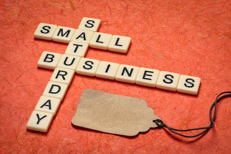 small business Saturday - crossword and blank price tag, holiday shopping conceptの写真素材