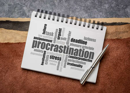 procrastination word cloud in a sketchbook against abstract paper landscape, productivity and personal development conceptの写真素材