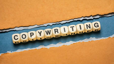 copywriting word abstract in wooden letter cubes against paper abstract, business marketing,...