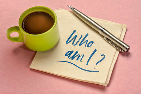 Who am I ? A philosophical question  on a napkin with coffee. Personal development, life purpose,...