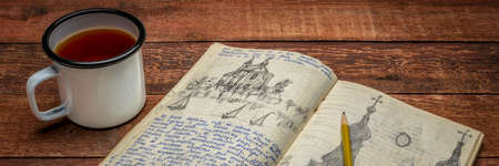 Vintage travel journal with handwriting and pencil sketches (property release attached)  on a rustic...