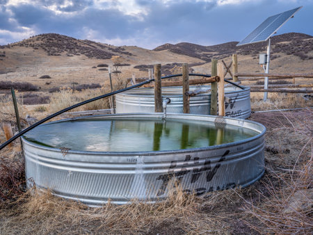 Fort Collins, CO, USA - November 23, 2020: Metal water stock tanks for cattle at Colorado foothills - Soapstone Natural Area in fall scenery.のeditorial素材