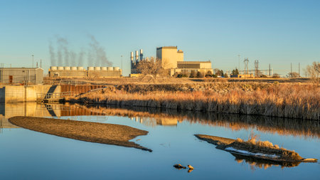 Fort Saint Vrain Generating Station near Plateville, Colorado, originally built as a nuclear power plant, currently powered by natural gas, distant view with St Vrain Creek in frontのeditorial素材