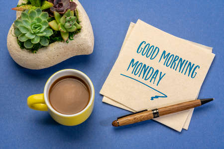 Good Morning Monday - cheerful handwriting on a napkin with a cup of coffee, desktop flat layの写真素材
