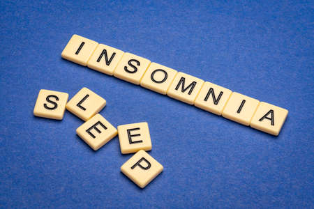 insomnia and sleep words in letter tiles - health and wellbeing concept
