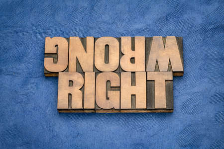 right or wrong ethical choice  dilemma - iword abstract in vintage wood letterpress printing blocks, ethics conceptの写真素材