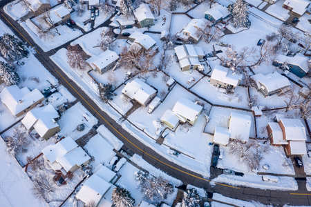 street in a residential area of Fort Collins in northern Colorado after heavy snowstorm, aerial view of late winter or early spring sceneryの写真素材