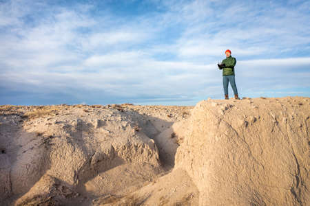 senior male drone pilot in a rugged terrain of Pawnee National Grassland in northern Coloradoの写真素材