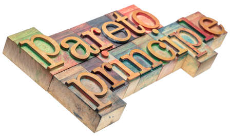 Pareto principle - isolated word abstract in wood letterpress printing blocks stained by color inks,...