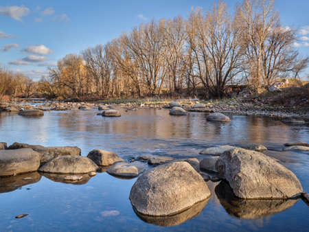 Poudre River above Fort Collins, Colorado, where diversion dam was removed and replaced by natural boulders, early spring sceneryの写真素材