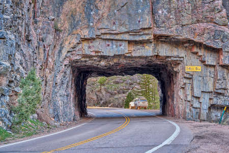 highway tunnel in the mountain river canyon - Cache la Poudre River at Little Narrows above Fort Collins in northern Colorado, early spring sceneryの写真素材