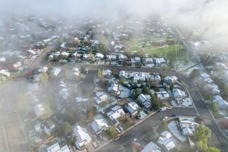 foggy spring morning over residential area of Fort Collins in northern Colorado after heavy rain and...