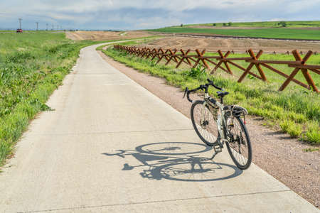 touring bicycle in early summer on a bike trail between Loveland and Fort Collins in northern Colorado, recreation and commuting conceptの写真素材