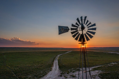 sunset over over plains with old windmill, Pawnee National Grassland in Colorado, aerial viewの写真素材