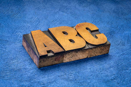 abc, a, b, c - first three letters of alphabet in vintage wooden letterpress type blocks against handmade bark paper, essentials, start or beginning conceptの写真素材