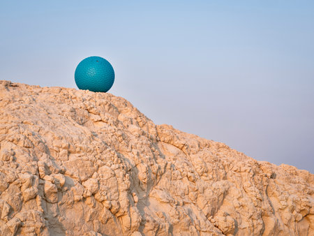 heavy rubber slam ball filled with sand on at a clay cliff, outdoor exercise and fitness conceptの写真素材