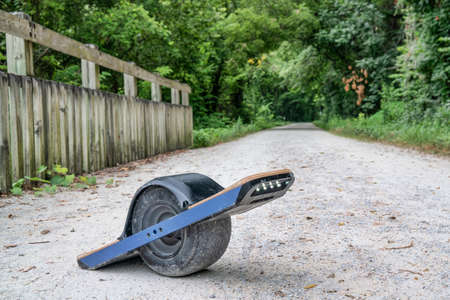 One-wheeled electric skateboard (personal transporter) on a gravel bike trailの写真素材