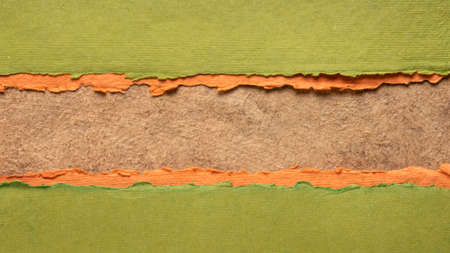 paper abstract in brown, orange and green with a copy space - sheets of handmade paper,  blank web...