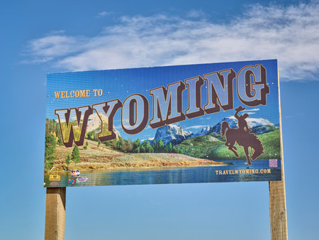 Cheyenne, WY, USA - April 2, 2021: Welcome to Wyoming - road sign with some stickers added by travelersの写真素材