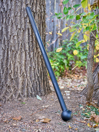 steel mace (or macebell) on a a backyard, fitness concept using unconventional equipment