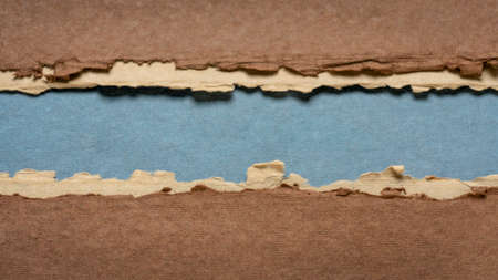 paper abstract in brown, blue and beige with a copy space - sheets of handmade paper, blank web...