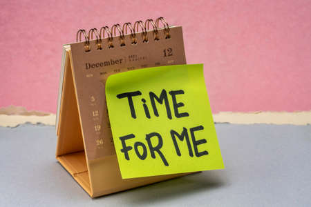 time for me reminder note on a desktop calendar, self care and personal development conceptの写真素材