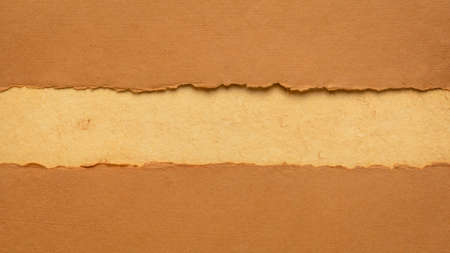 paper abstract in orange and pumpkin tones with a copy space - sheets of handmade paper, blank web banner for alert, warning or dangerの写真素材
