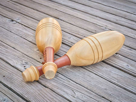 pair of Indian exercise clubs on a wooden deck - functional fitness concept, clubs are particularly...