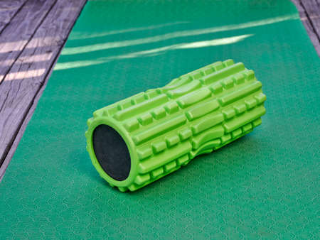foam roller - medium density deep tissue massager for muscle massage and myofascial trigger point release, fitness, care and recovery conceptの写真素材